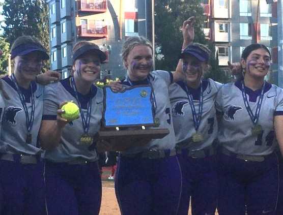 Ridgeview pitcher Brezlyn Hagemeister (3) holds the state championship trophy after throwing a three-hitter against Thurston.
