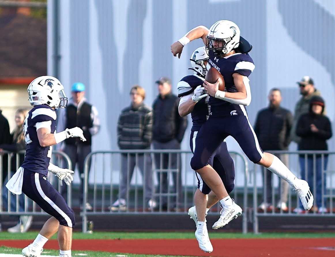 Marist Catholic's Brody Buzzard celebrates after returning an interception for a touchdown in a 4A semifinal.(Photo by JR Olson)