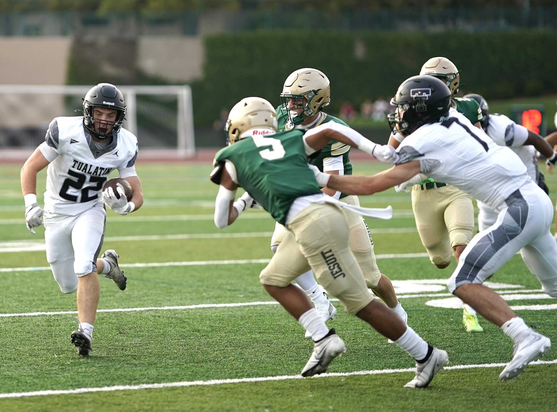 Sophomore Iden Rule (22) led Tualatin in rushing Friday, carrying 18 times for 68 yards in a 13-7 victory. (Photo by J.R. Olson)