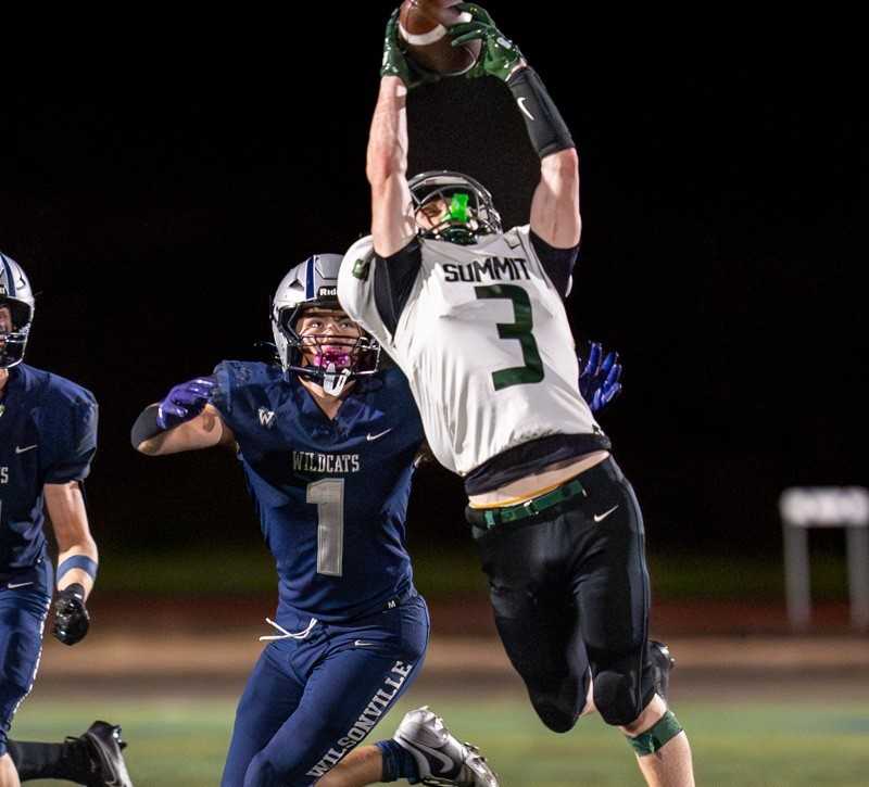 Summit's Wills Pinaire makes a grab against Wilsonville as the Storm won 28-20. (Courtesy photo: Michael Williams)