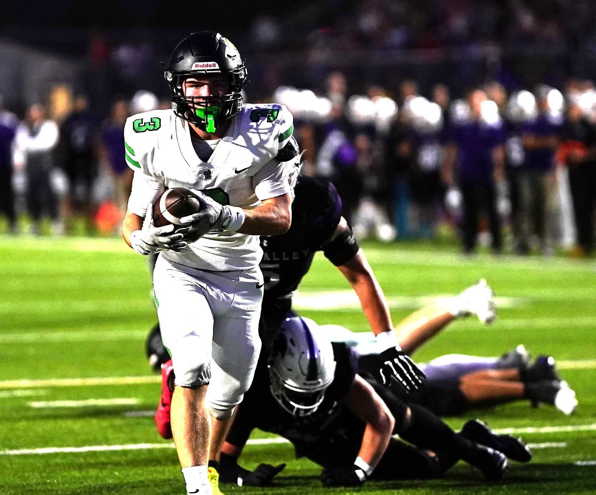 West Linn's Shane Peters runs for one of his two touchdowns in Friday's 31-24 win at Sumner, Wash. (Photo by J.R. Olson)