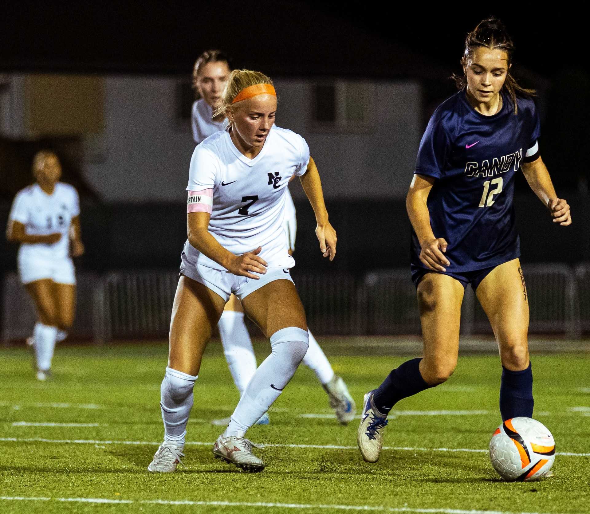 North Eugene's Payton Buschelman (7) shadows Canby's Abella Leder (12) in a Sept. 18 match. (Photo by Elliott Reynolds)