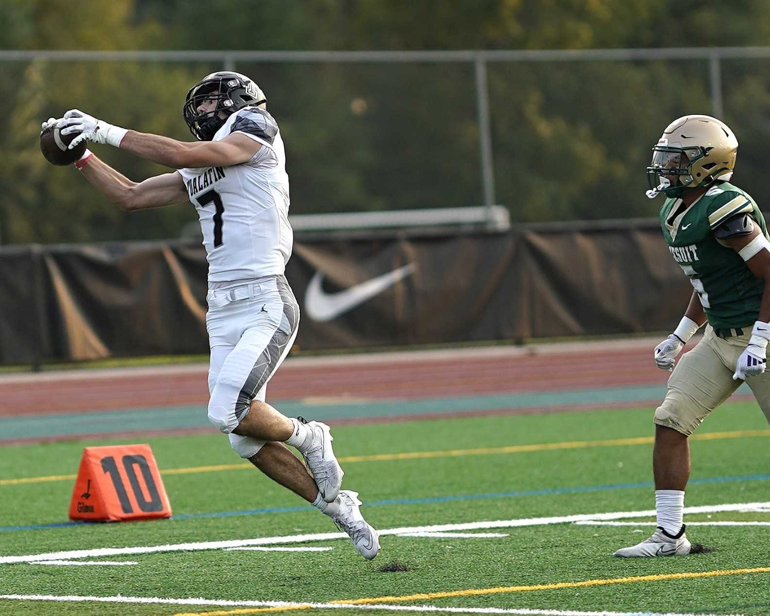 Tualatin's Trent Dearborn hauls in a long pass in the Timberwolves' nonleague win at Jesuit on Sept. 5. (Photo by J.R. Olson)
