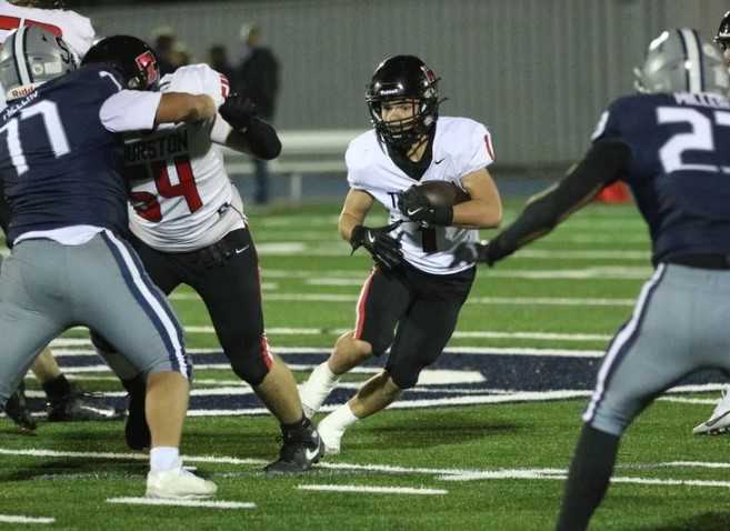 Thurston's Justin Fisher finds a gap behind center Jordan Barr in last week's win at Springfield. (Photo by Patrick A. Edmison)