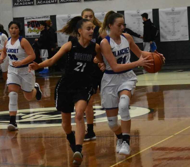 Blanchet Catholic's Hailey Ostby (right) works against the defense of Horizon Christian's Jaycie Forrester. (Jeremy McDonald)