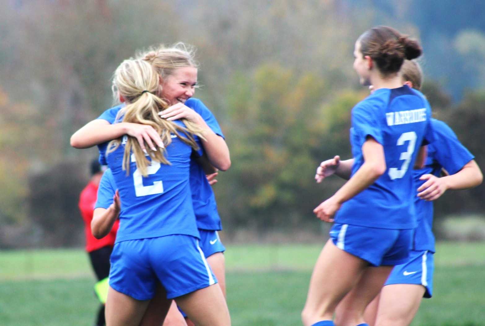 Amity senior Adie Nisly hugs senior Haley Miersma (2) after one of her two goals in Tuesday's win. (Photo by Jeremy McDonald)
