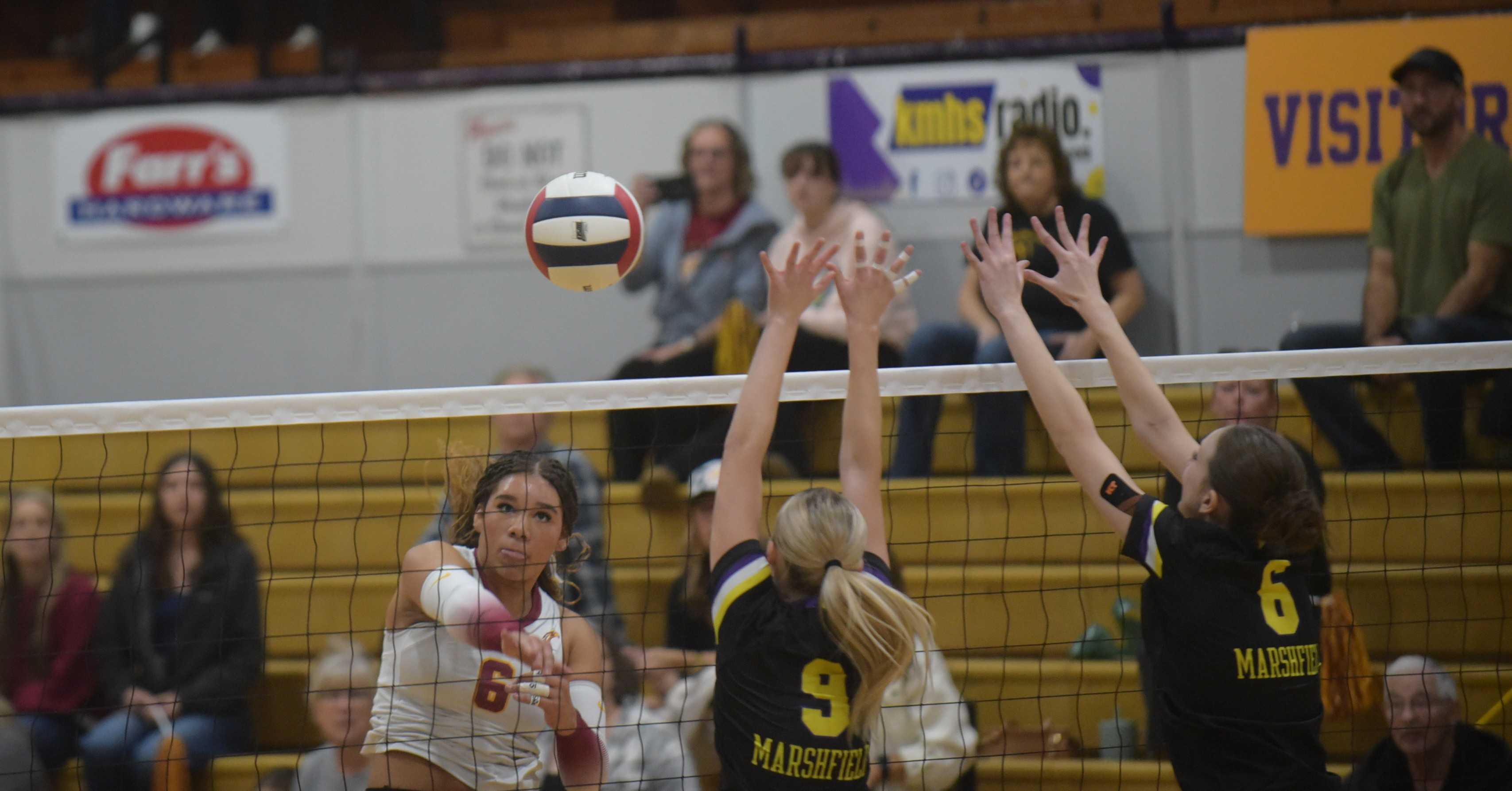 The Dalles star Jazlynn Morris-Holmes hits a kill past two Marshfield defenders. (John Gunther Photo)