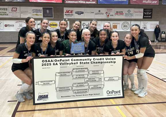 The Jesuit girls volleyball team celebrates after winning the 6A state title. (Photo by Chris Burkhardt)