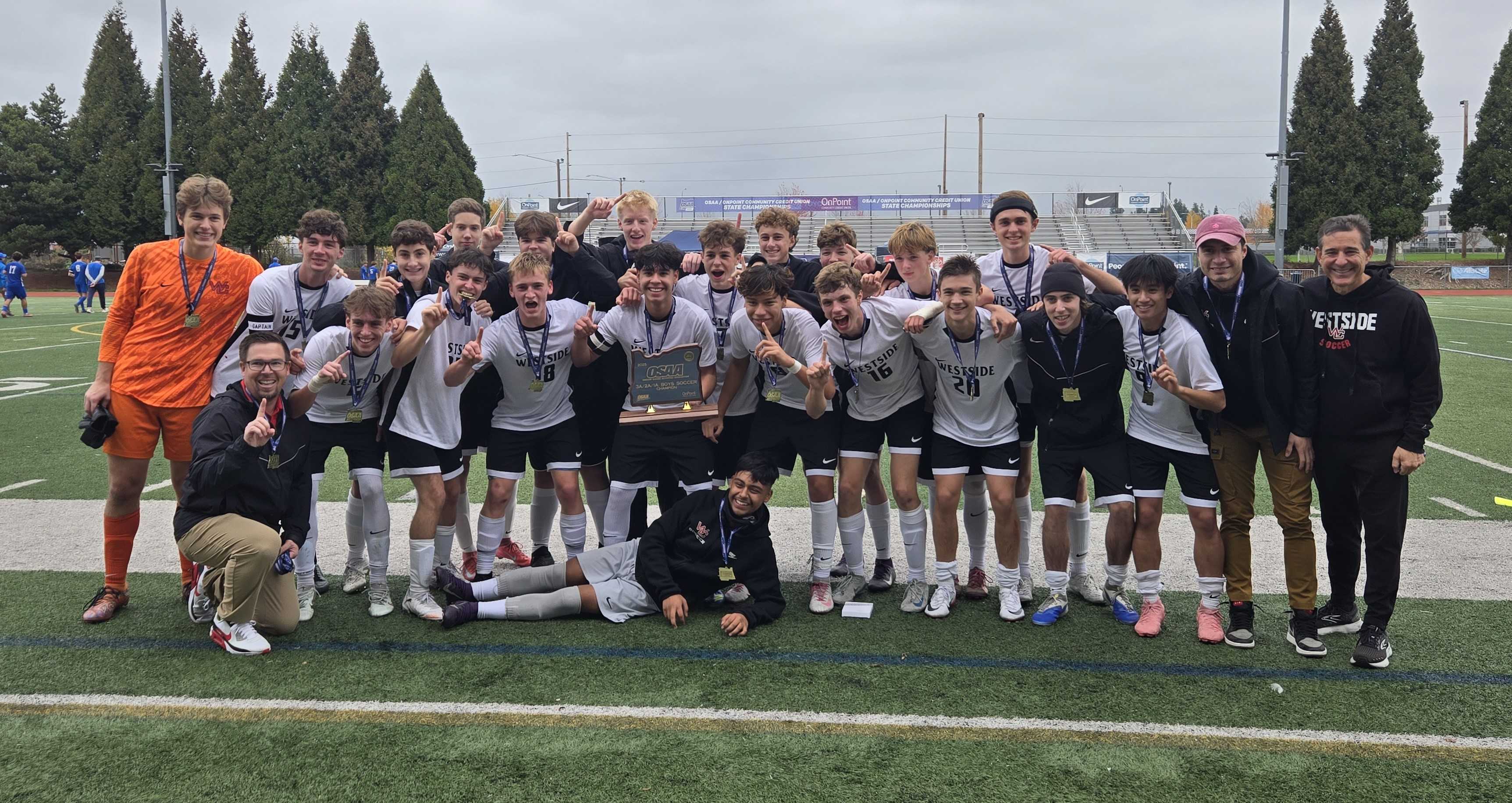 The Westside Christian boys soccer team celebrates with the state championship trophy. (Photo by Austin White)