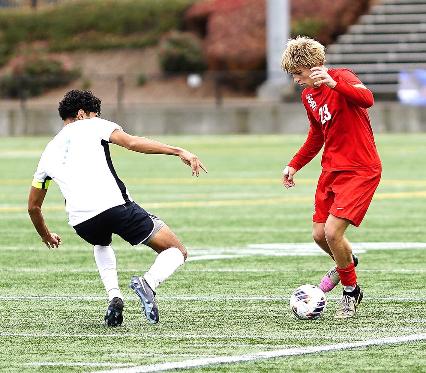 La Salle Prep's River Nichols (23) works against Corvallis' Faisal Alsharif in Saturday's 5A soccer final. (Photo by J.R. Olson)