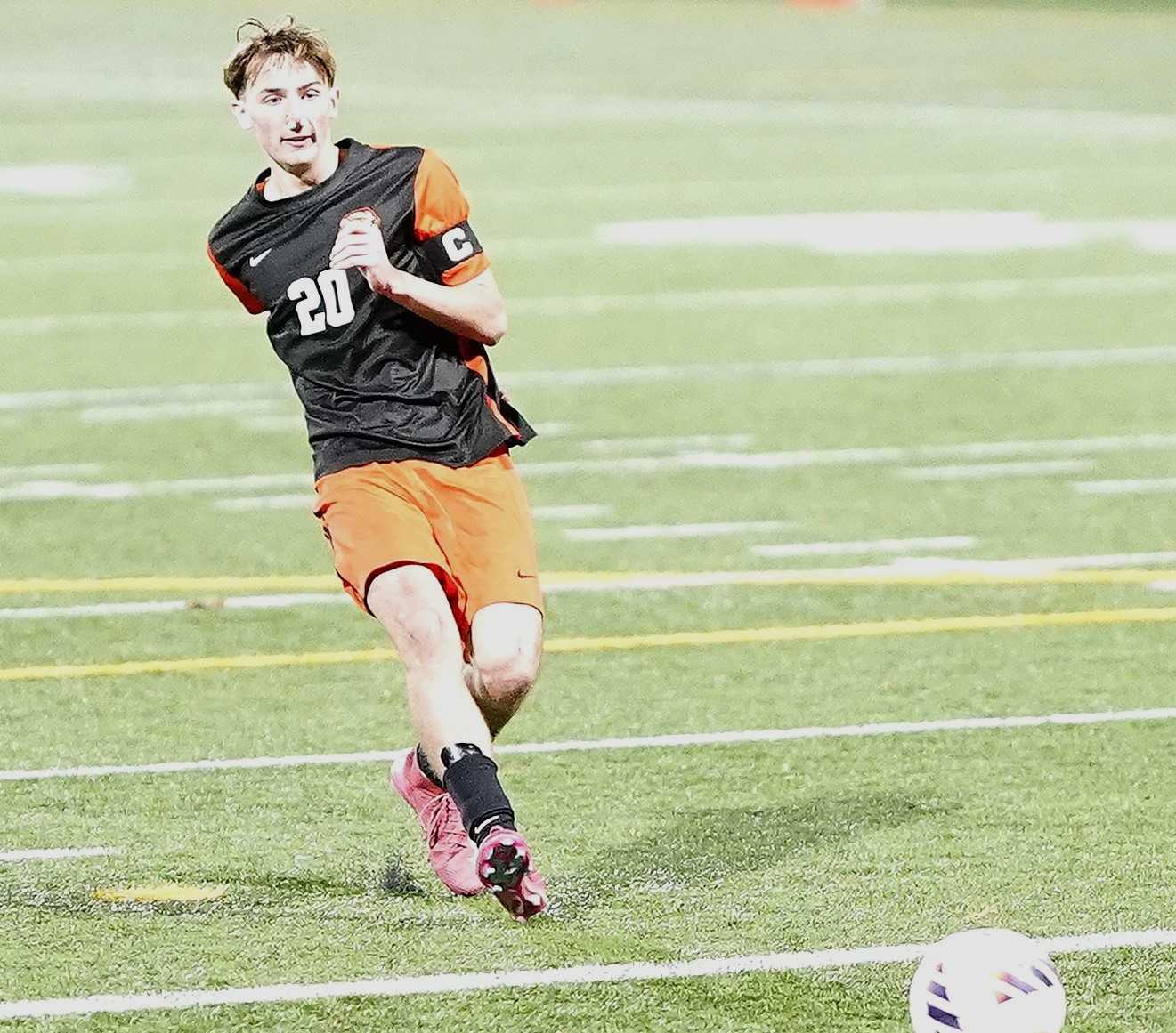 Cal Spear drives in the clinching penalty kick in Beaverton's win over Grant on Saturday night. (Photo by J.R. Olson)