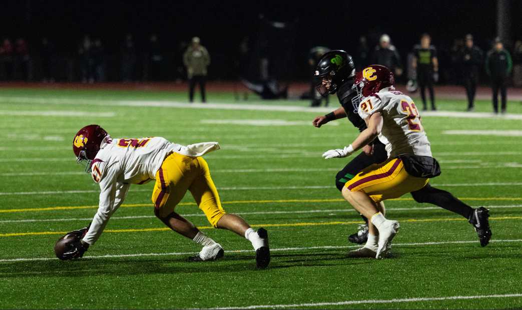 The Rams try to fall on a West Linn fumbled snap to end the game. (Photo by Ben Teese)