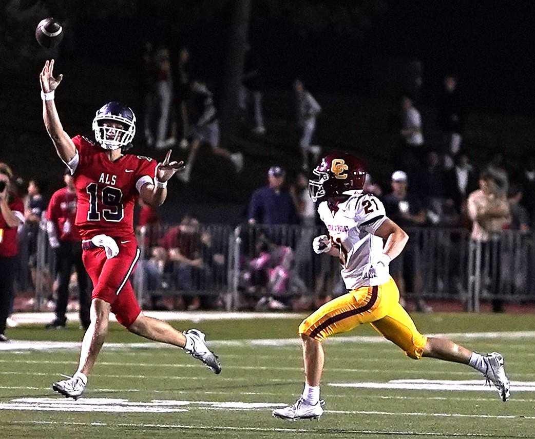 Lake Oswego quarterback Hudson Kurland avoids Central Catholic's Jake Wight in a Sept. 12 nonleague game. (Photo by J.R. Olson)