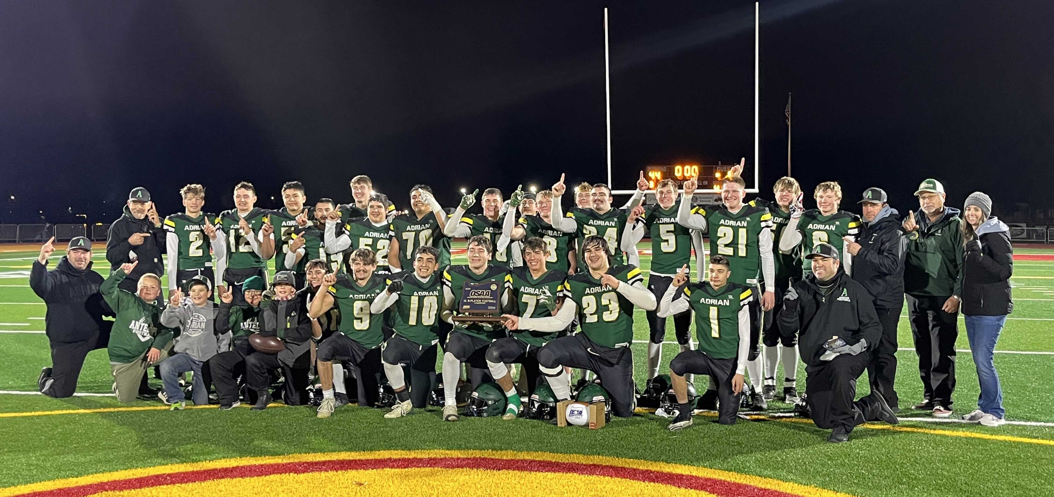 Adrian football poses with the state title trophy after defeating Crosspoint Christian. (Photo by Missy Smith)