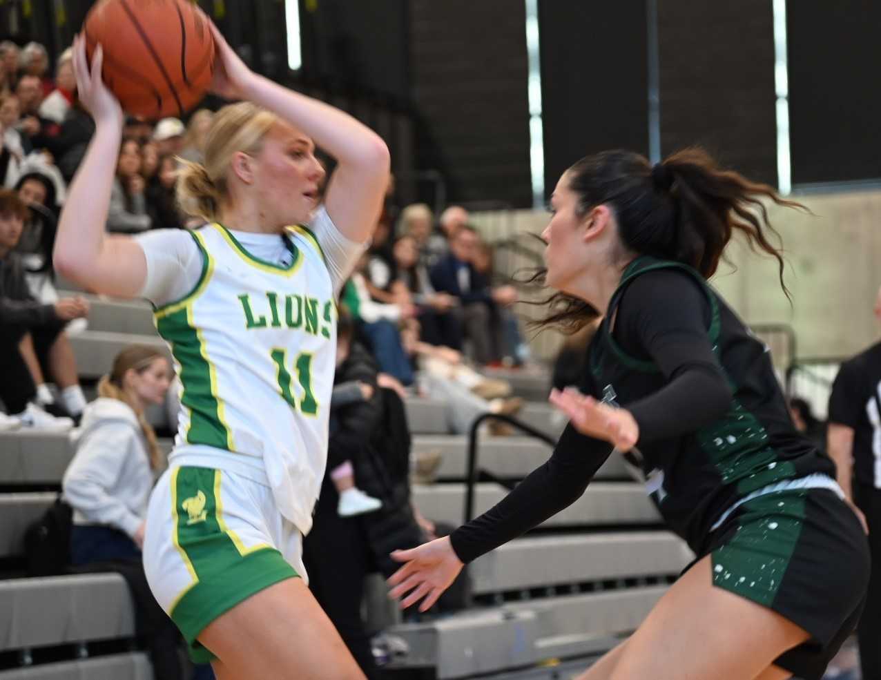 West Linn's Reese Jordan (11) looks to pass around West Salem's Emma Zuniga on Saturday. (Photo by Jeremy McDonald)