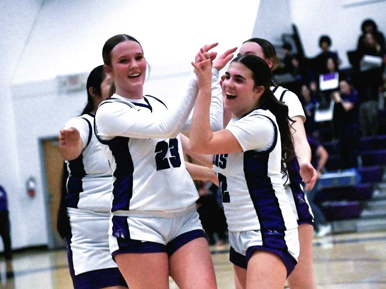Jefferson's Luella Campbell (23) high-fives Genevieve Orton after Wednesday's win over Burns. (Photo by Jeremy McDonald)