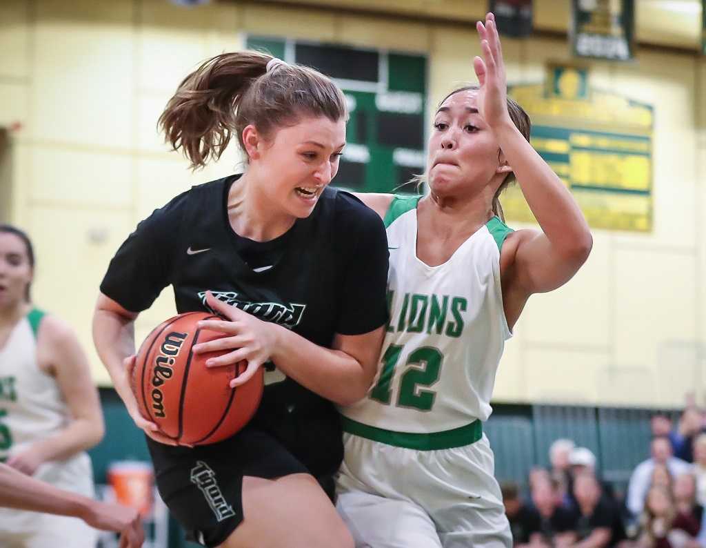 Tigard's Campbell Gray works against the defense of West Linn's Payton Shelstad on Friday night.