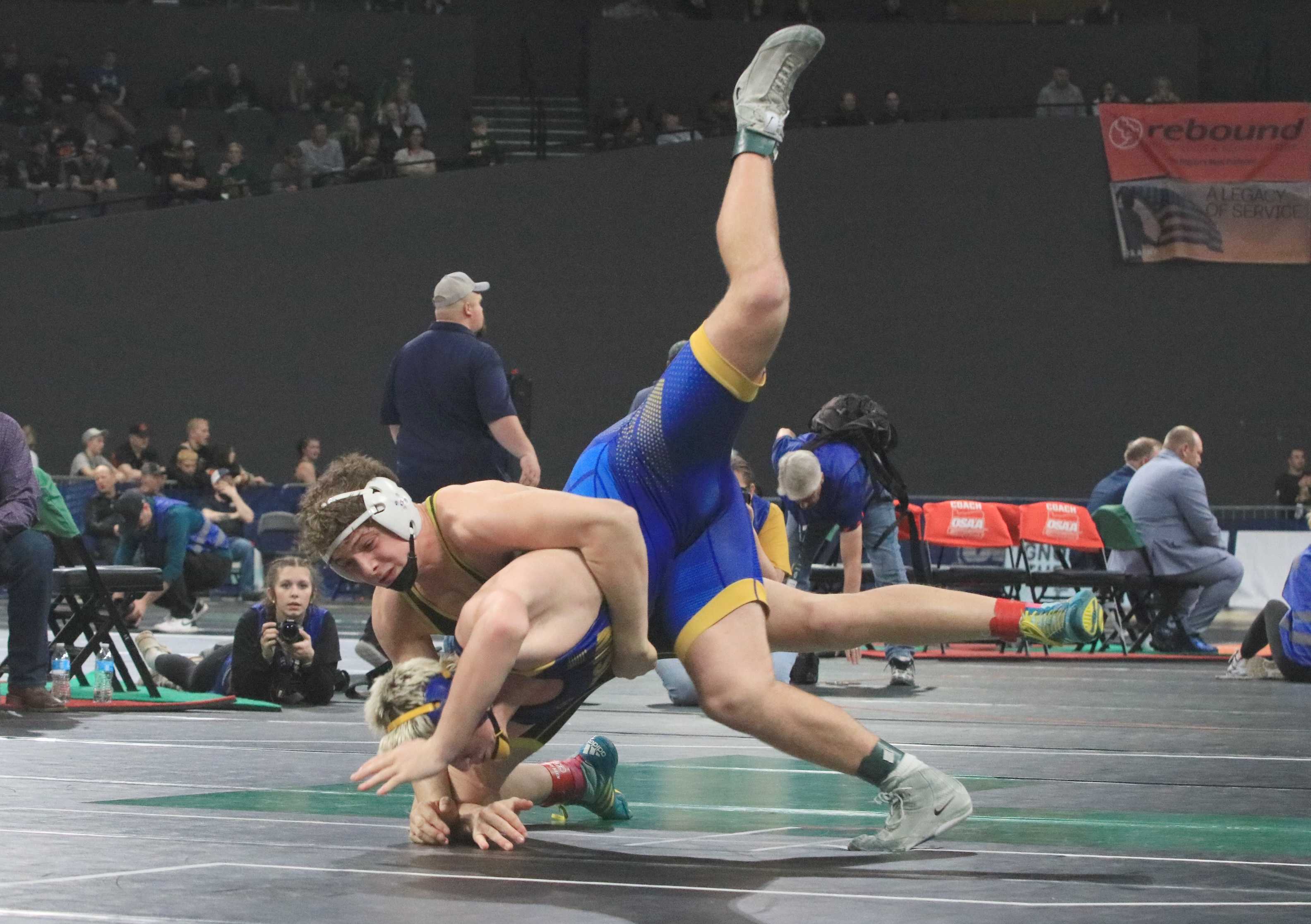 Harrisburg's Brody Buzzard takes down Siuslaw's Jacob Mann during Friday's 3A boys wrestling finals at Memorial Coliseum.