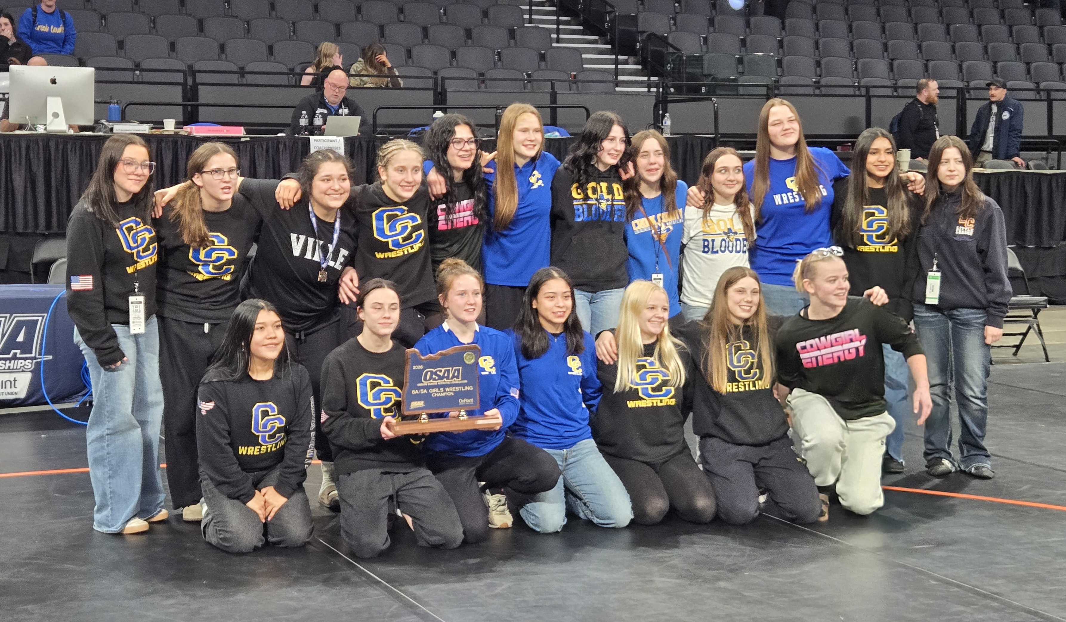 The Crook County girls wrestling team poses with the 6A/5A first-place trophy. (Photo by Austin White)