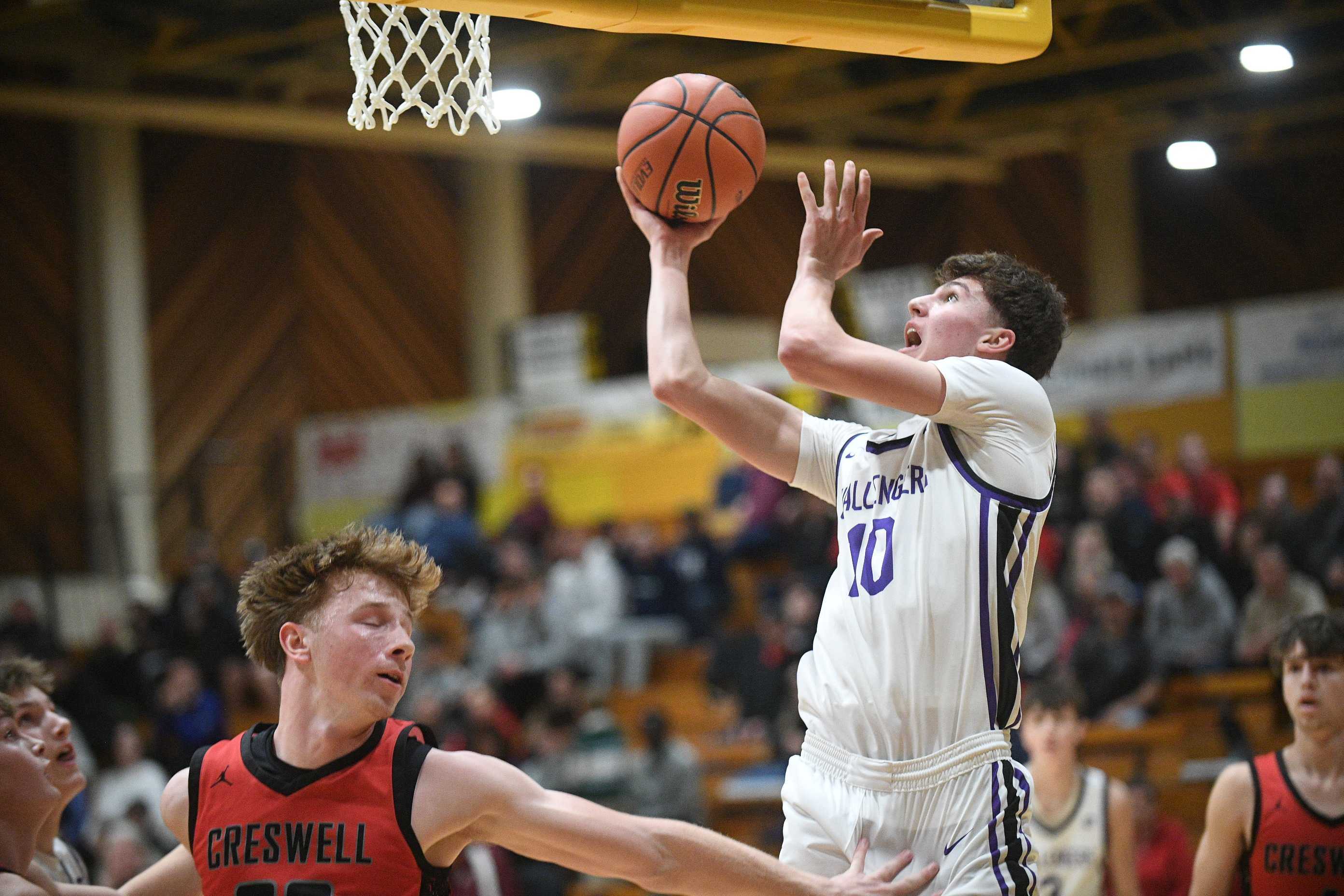 Cascade Christian's Andy Alvarez drives to the hoop for two points against Creswell on Thursday (John Gunther photo).