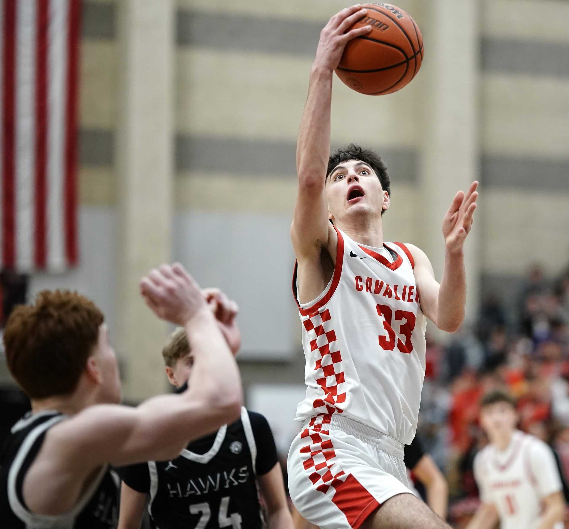 Clackamas junior R.J. Barhoum drives to the basket in Friday's 6A playoff win over visiting Nelson. (Photo by JR Olson)