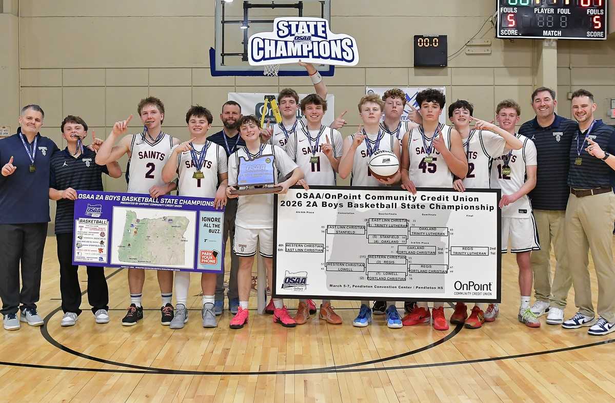 Trinity Lutheran poses with its first state championship trophy after defeating Regis on Saturday night. (Photo by Andre Panse)