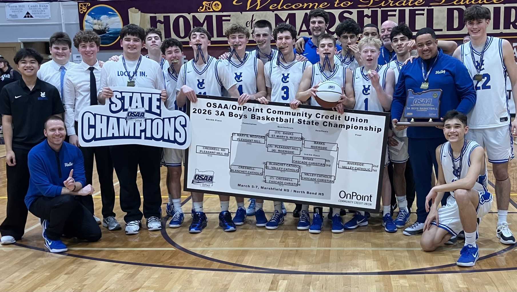 Valley Catholic celebrates with the championship bracket Saturday night at Marshfield High School. (John Gunther photo)