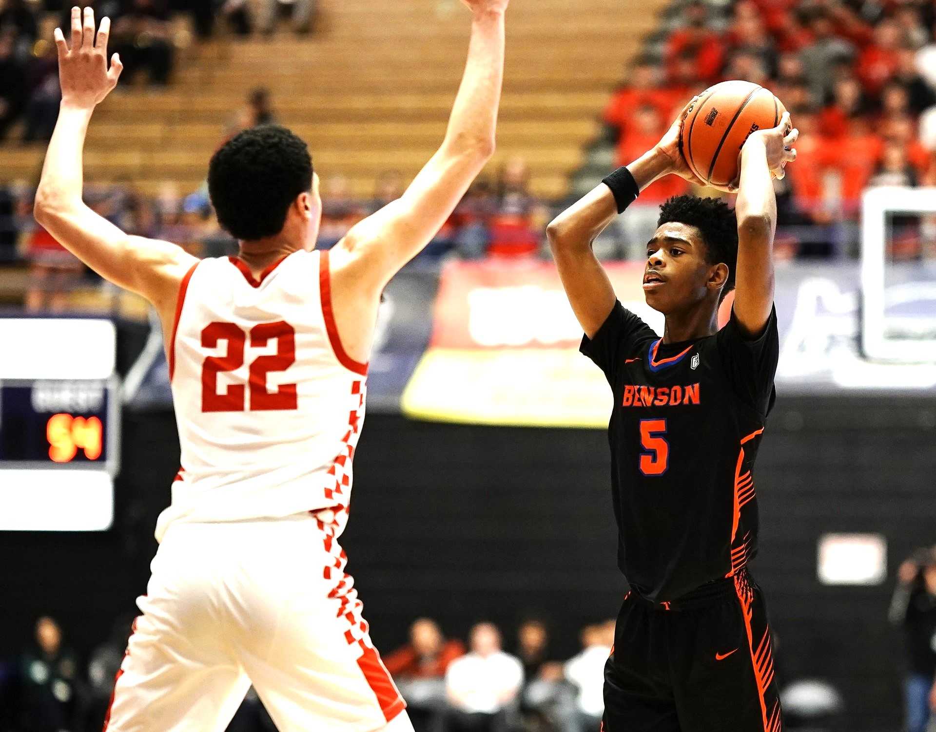 Benson freshman Kendall Hopkins-McGlothen looks to pass around Clackamas senior Syrius Owens. (Photo by J.R. Olson)