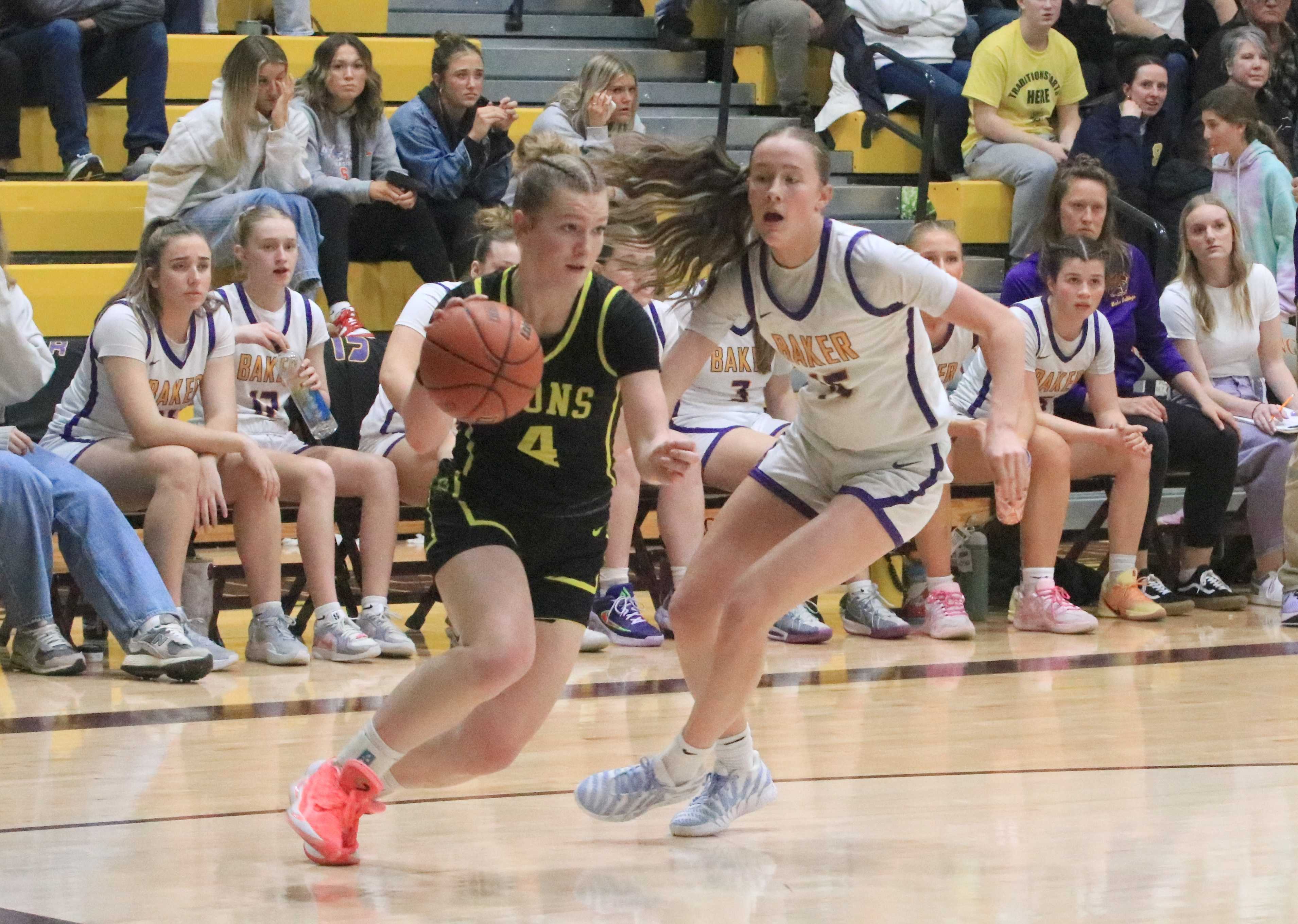 St. Helens' Madelyn Hancock (4) drives baseline against Baker's Molly Rasmussen in Friday's 4A girls basketball semifinal.