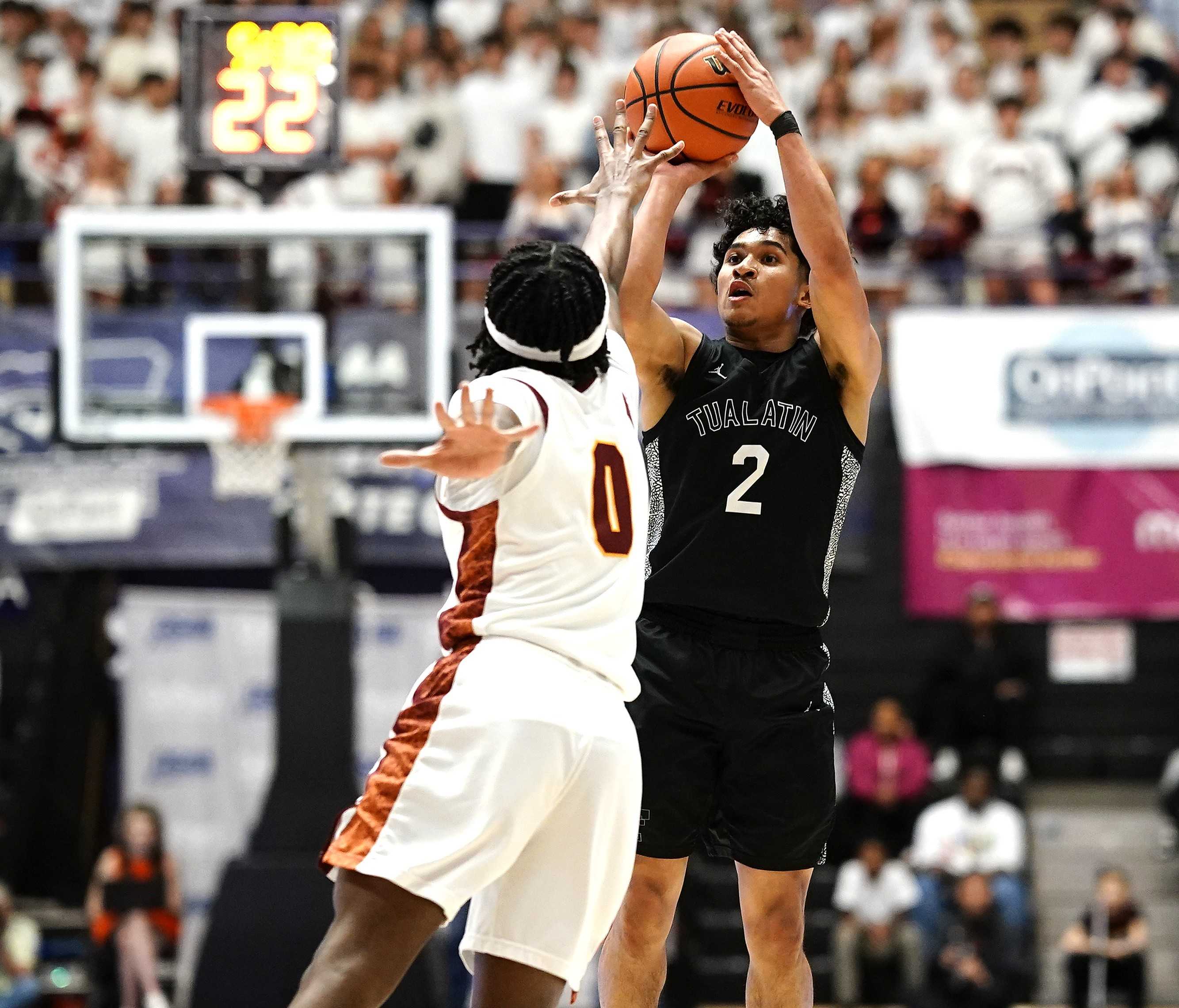 Tualatin’s Pat Vialva Jr. shoots over Central Catholic's Malcolm Weatherspoon in Saturday's 6A final. (Photo by J.R. Olson)