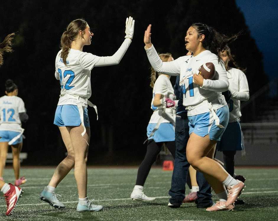Liberty's Lili Mendez Martinez (41) is congratulated by Emma Shilling (22) after scoring a touchdown. (Photo by Nathaniel Heath)