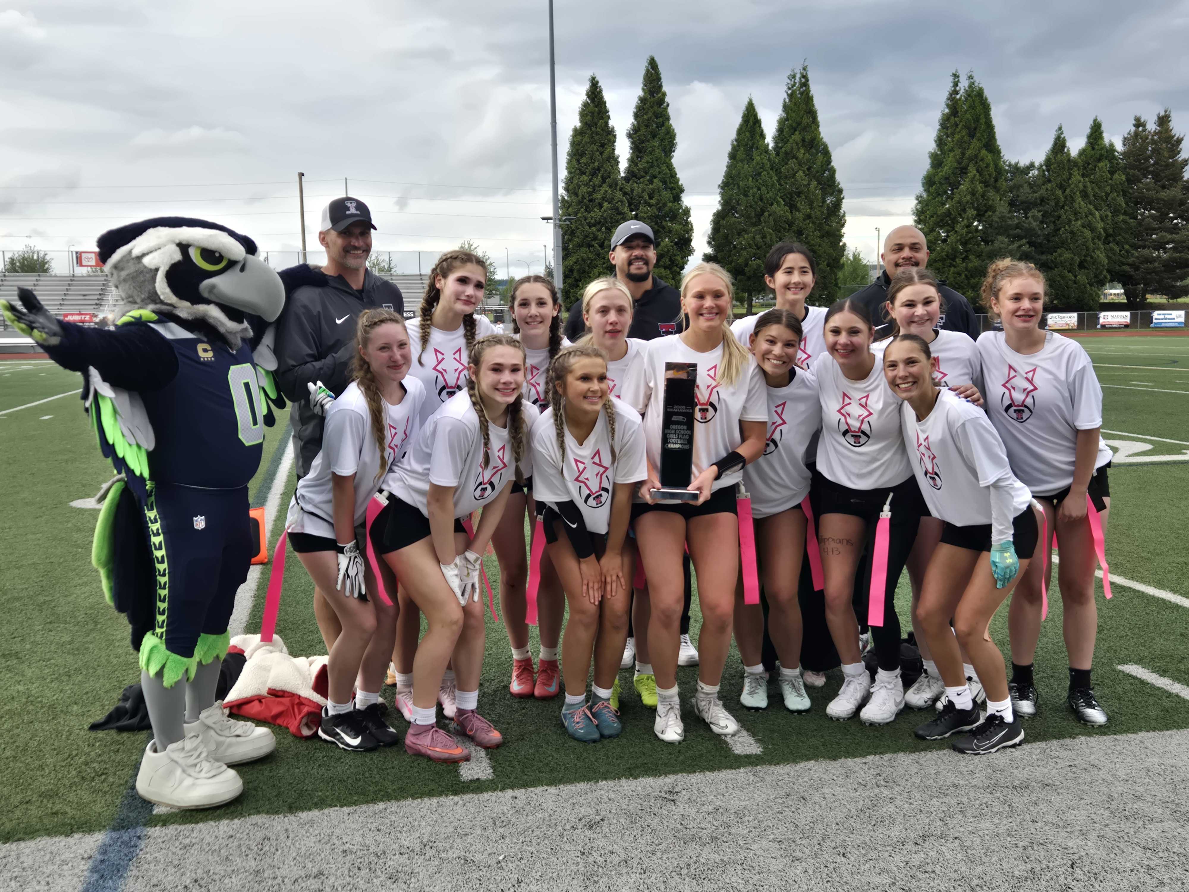 The Tualatin girls flag football team poses with the state championship trophy. (Photo by Austin White)