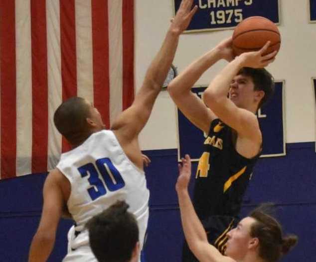 Bend's Brian Warinner shoots against the defense of McNary's Boston Smith on Tuesday. (Photo by Jeremy McDonald)