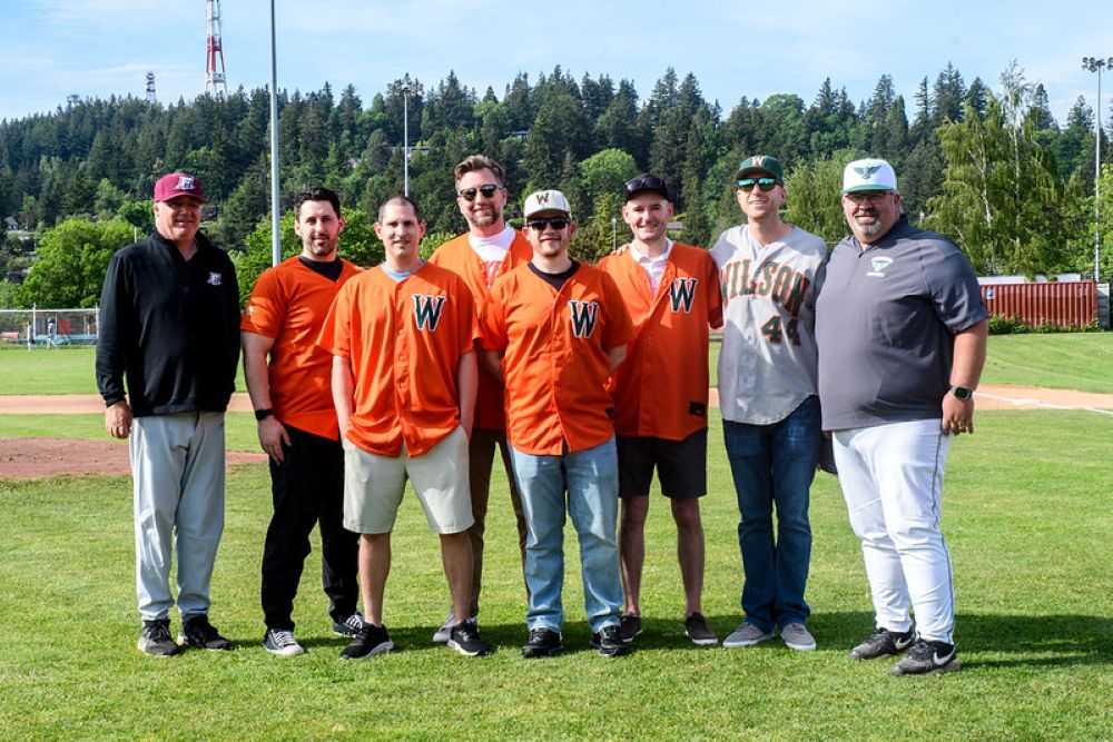 Andy Berger, left, and Jeremy Shetler, right, flank 2006 state-championWilson grads they coached as freshmen