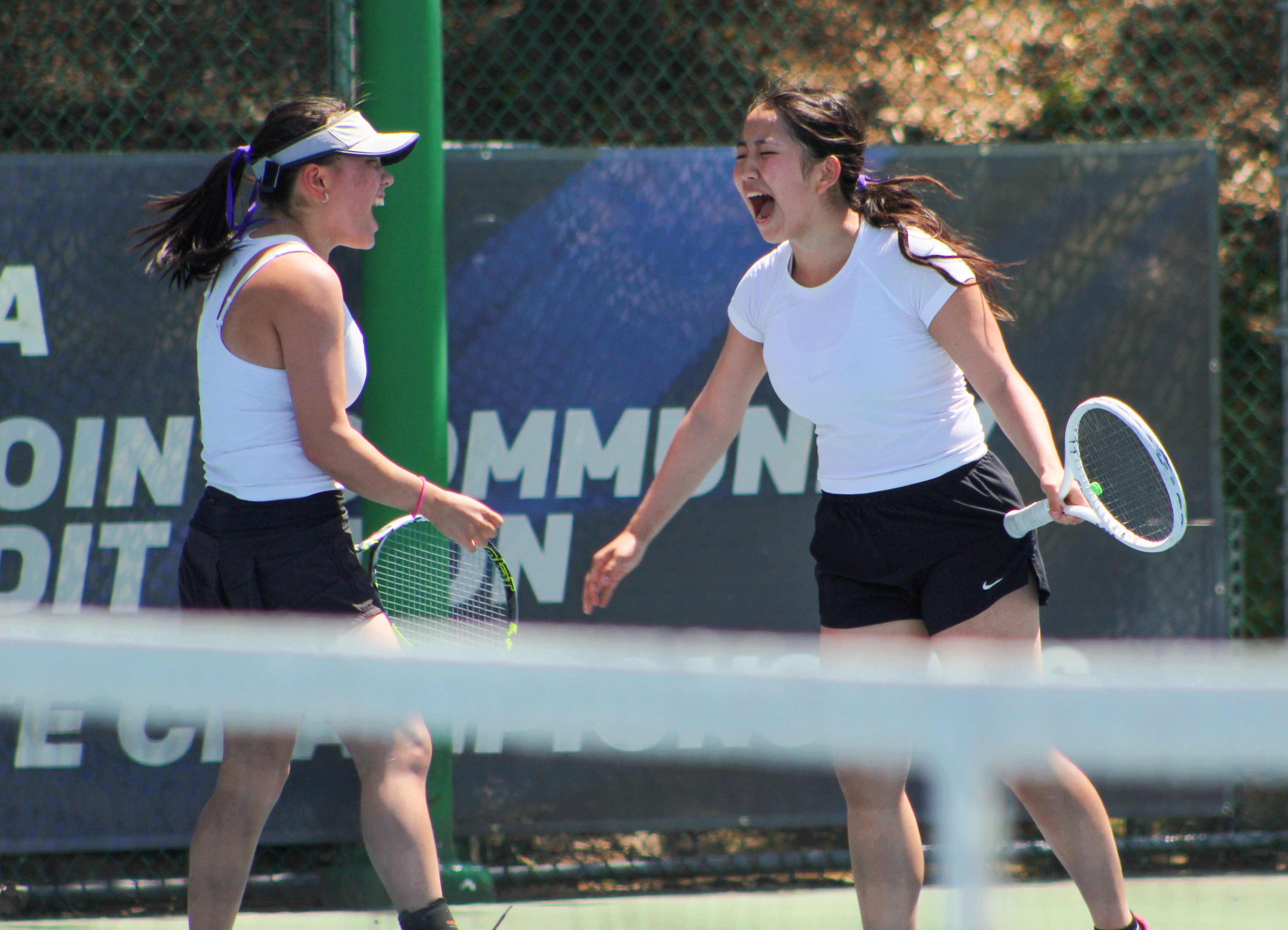 South Eugene's Rosalyn Cho, left, and Ellie Park celebrate a point scored in the state final. (Photo by Austin White)