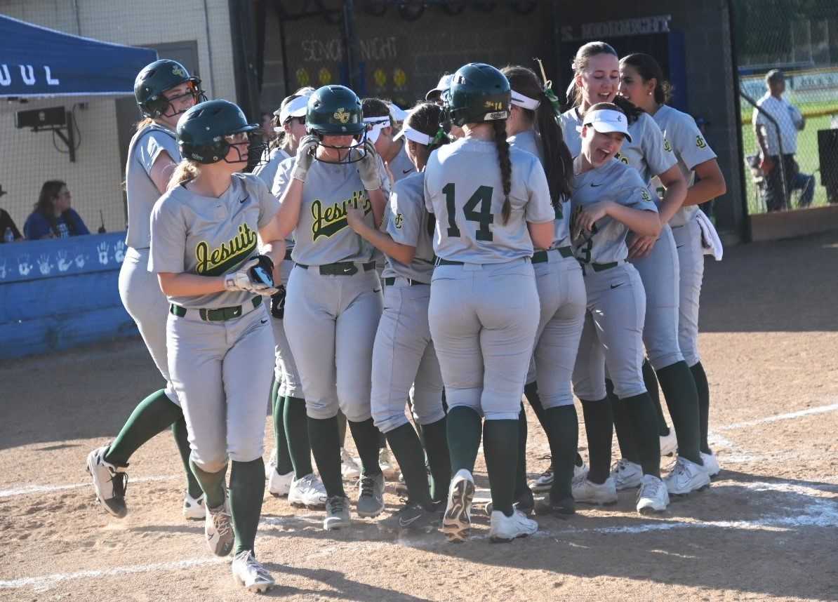 Jesuit players celebrate with Olivia Hildreth after her two-run home run in the sixth inning. (Photo by Jeremy McDonald)