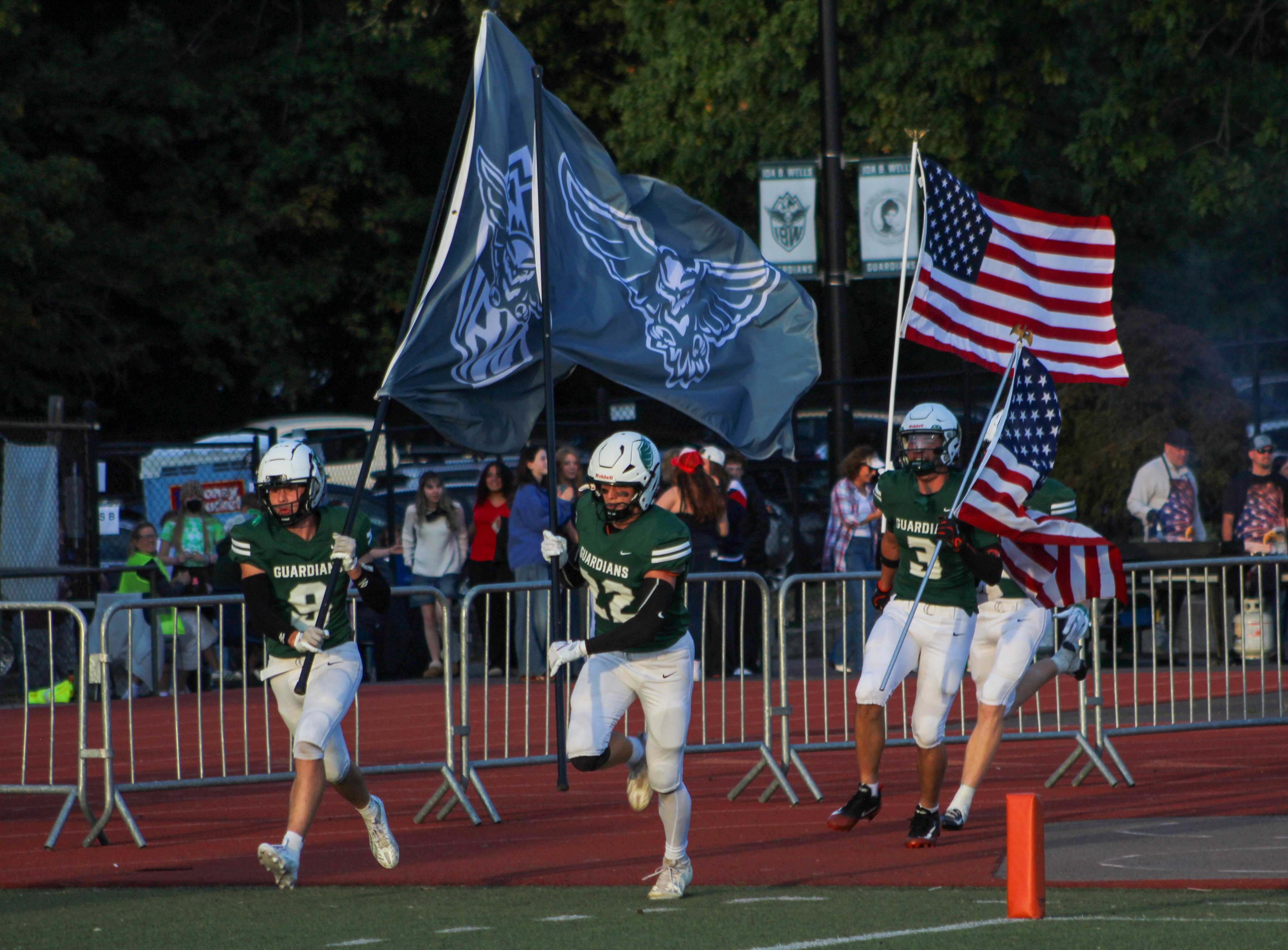 Ida B. Wells football players run onto the field before facing Roosevelt on Sept. 11, 2026. (Photo by Austin White)
