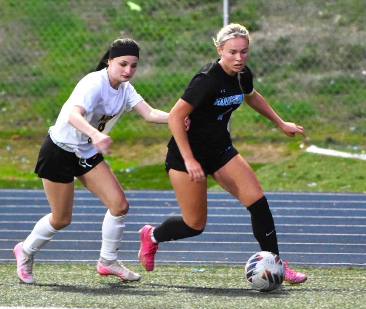 Marist Catholic's Libby McLaughlin (right) has 100 goals and a state-record 110 assists in her career. (Photo by Leticia Ficek)
