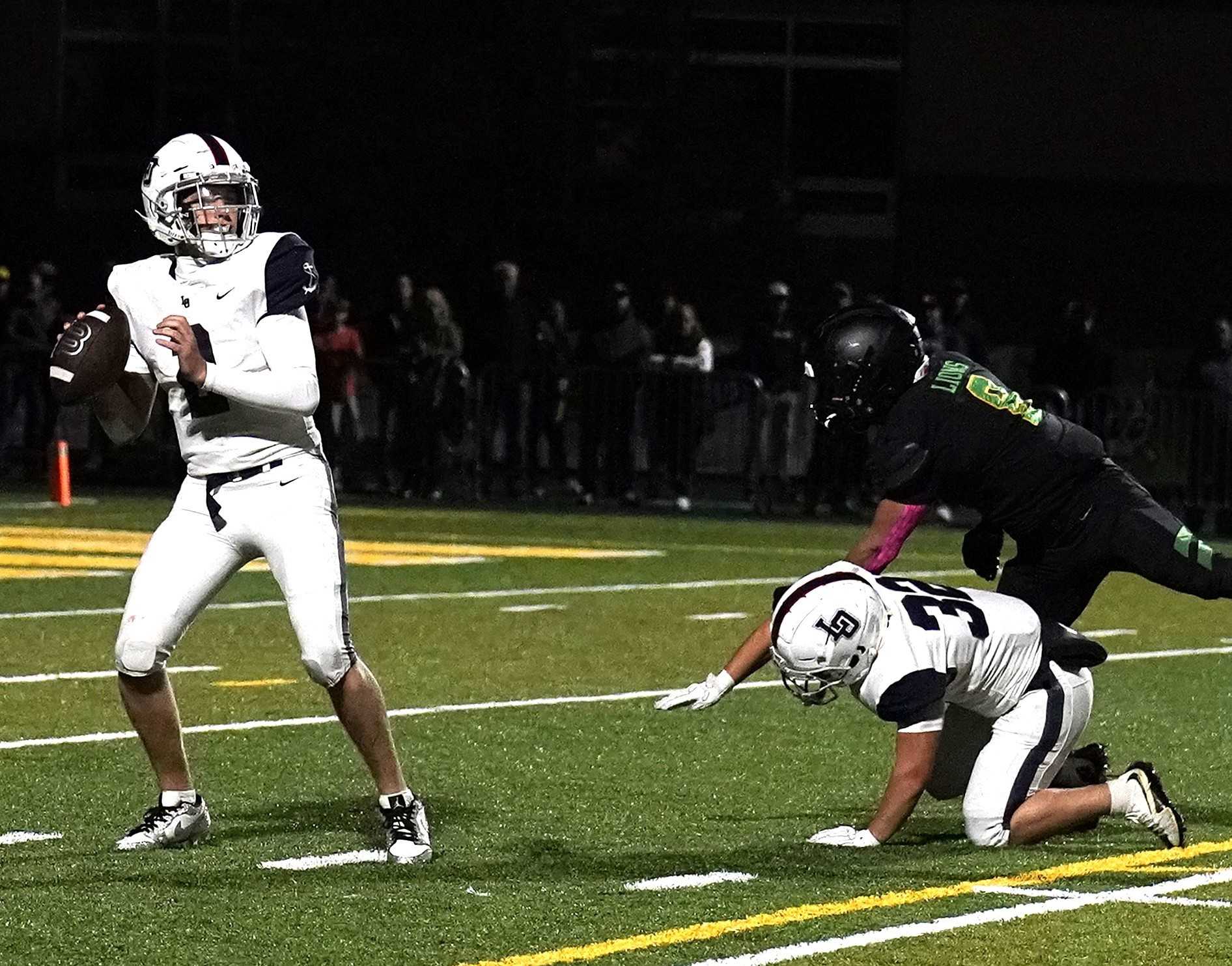 Lake Oswego quarterback Ryder Lemm passed for two touchdowns and ran for a score Friday night. (Photo by JR Olson)
