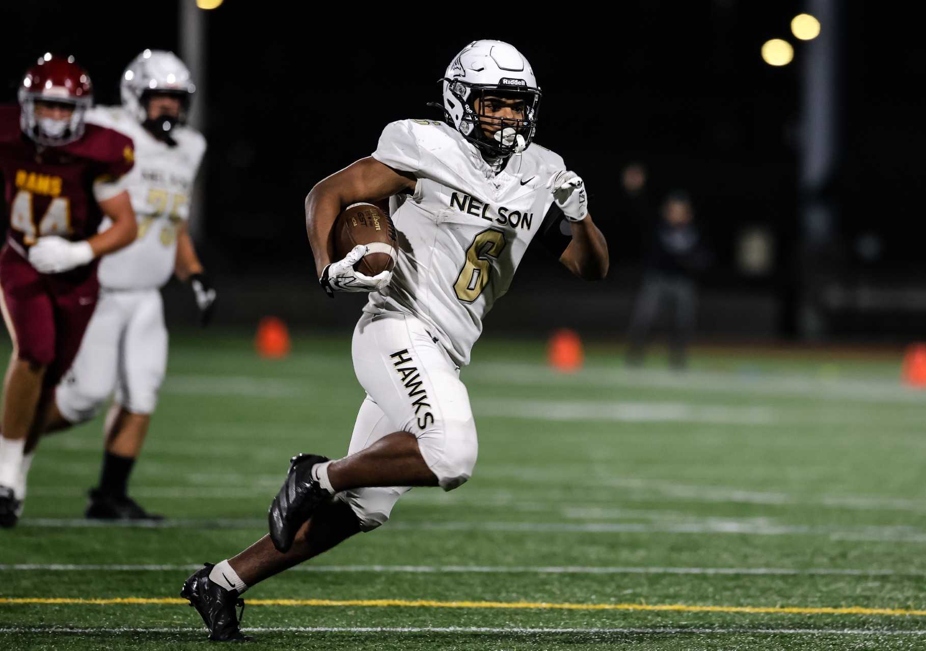 Nelson's Kevin Cohen runs for a 22-yard touchdown to put his team ahead in the fourth quarter Friday. (Photo by Ryan Fanger)