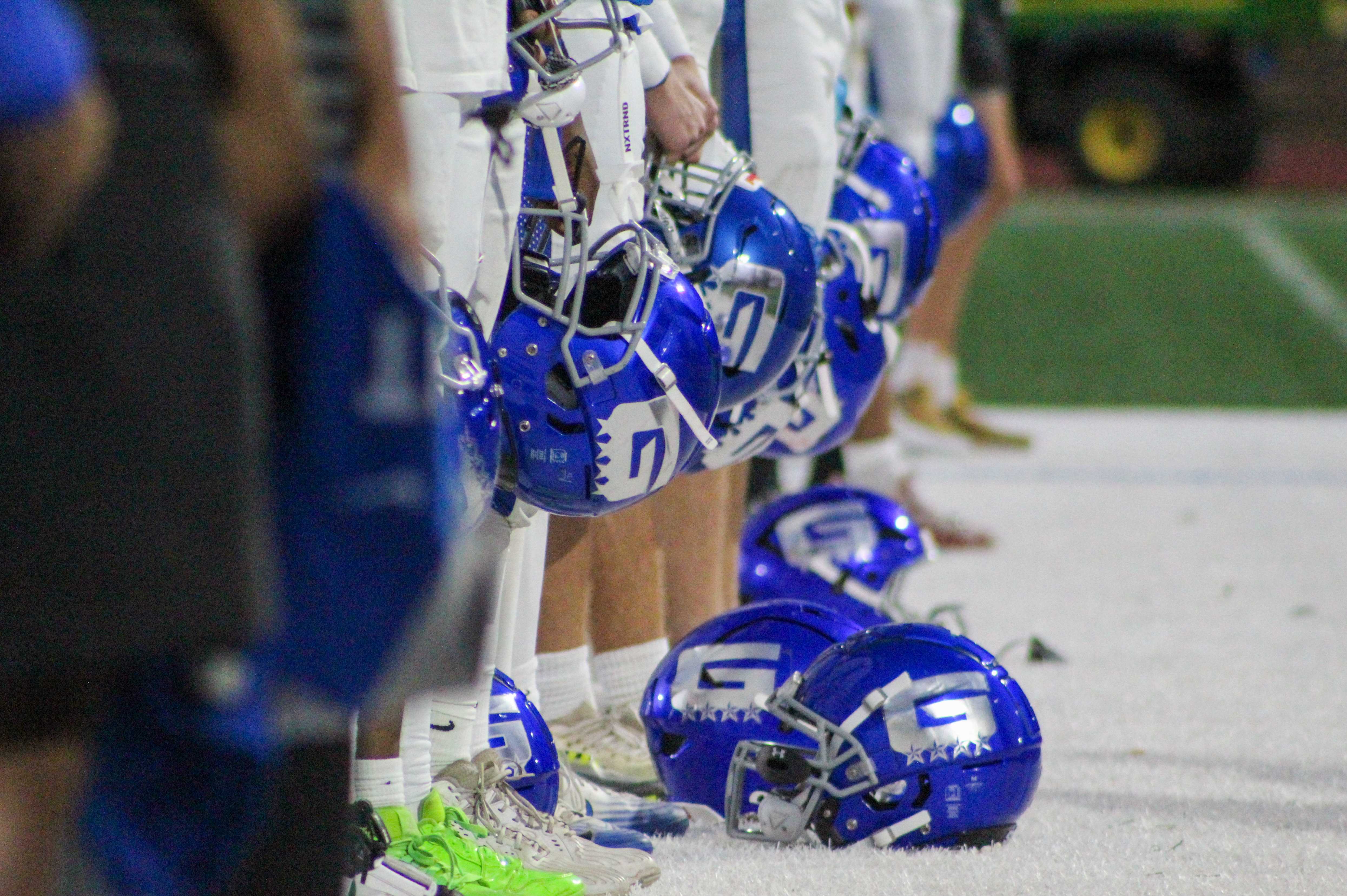 Grant football players line up for the national anthem before a game against Cleveland. (Photo by Austin White)
