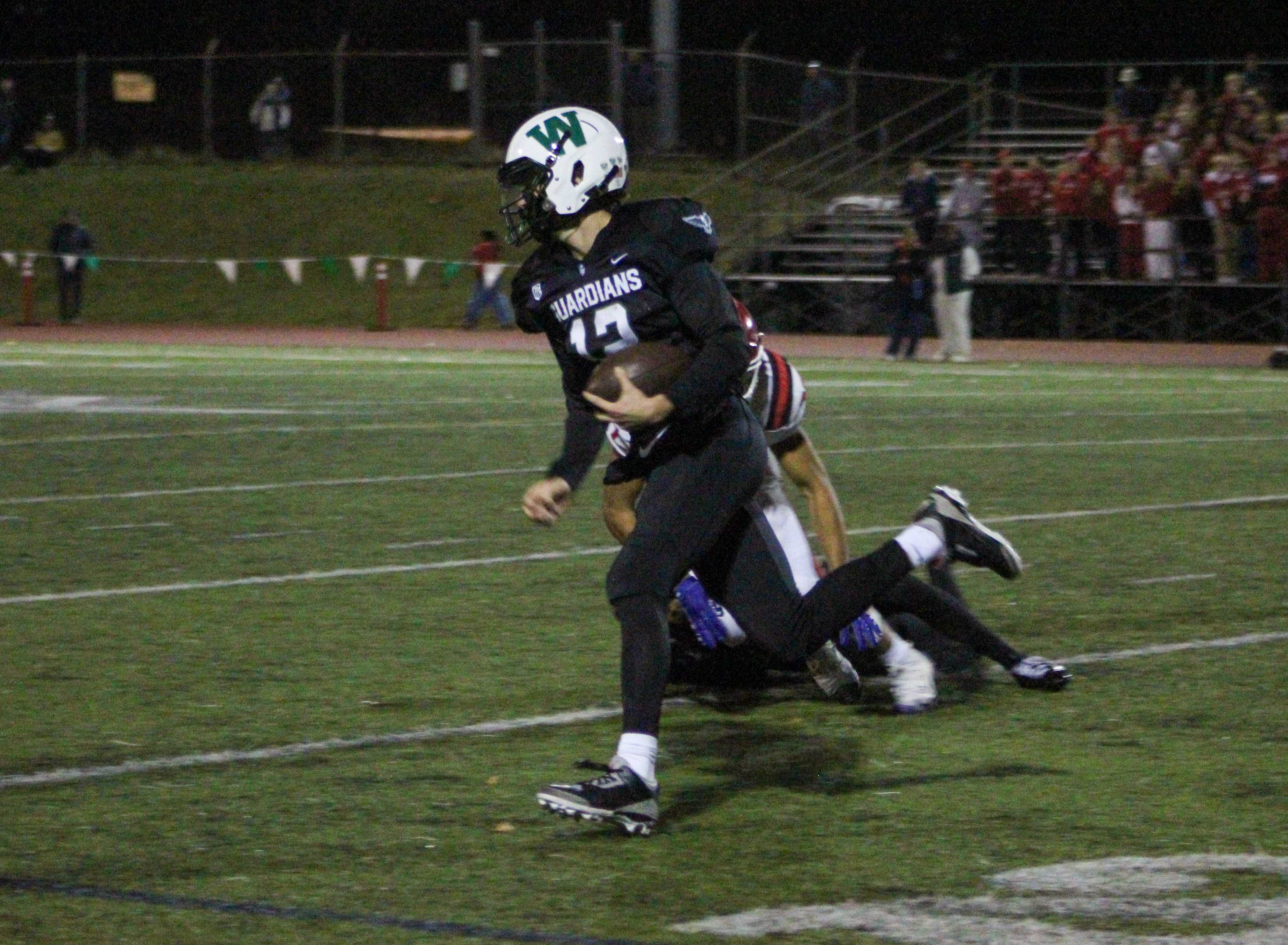 Wells senior Jude Nolan runs to the outside on a 79-yard TD run against Lincoln. (Photo by Austin White)