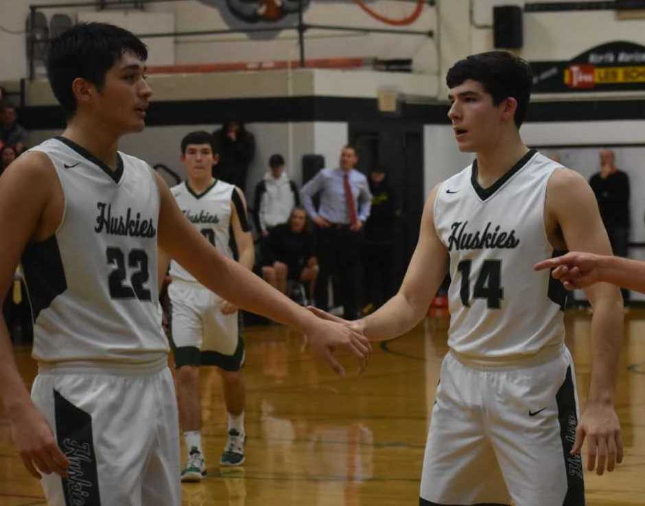 North Marion's Sergio Jimenez (22) and Grant Henry (14) slap hands in Friday's win over Gladstone. (Photo by Jeremy McDonald)