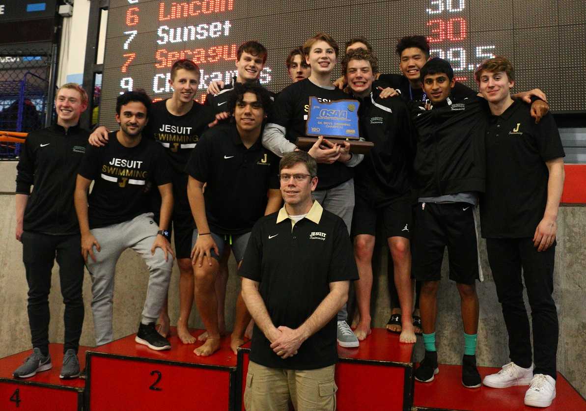 Coach Bryan Butcher and the Jesuit Crusaders pose with their fifth consecutive state title trophy. (NW Sports Photography)