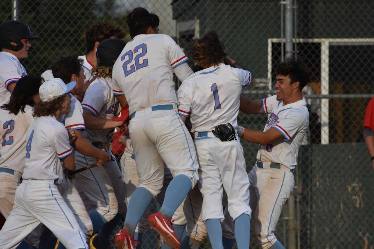 South Salem players swarm Kaiden Doten after his walk-off grand slam Wednesday. (Photo by Jeremy McDonald)